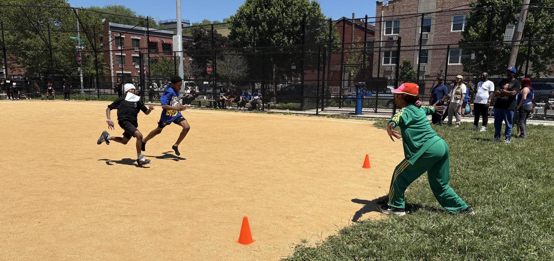 two students racing towards teacher