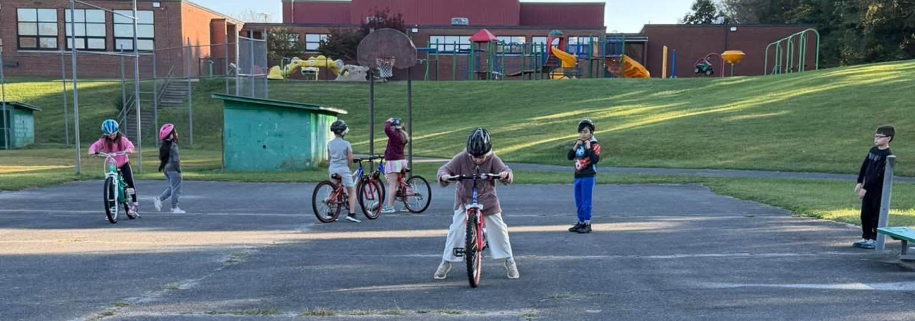 4th and 5th grade students learn bike safety and practice riding bikes