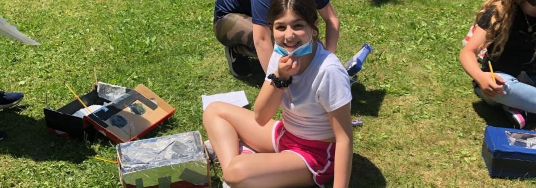 Female student on lawn during science class