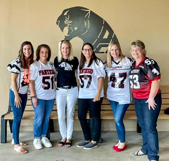 PCA staff members wearing football jerseys