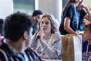 A student speaks into a microphone