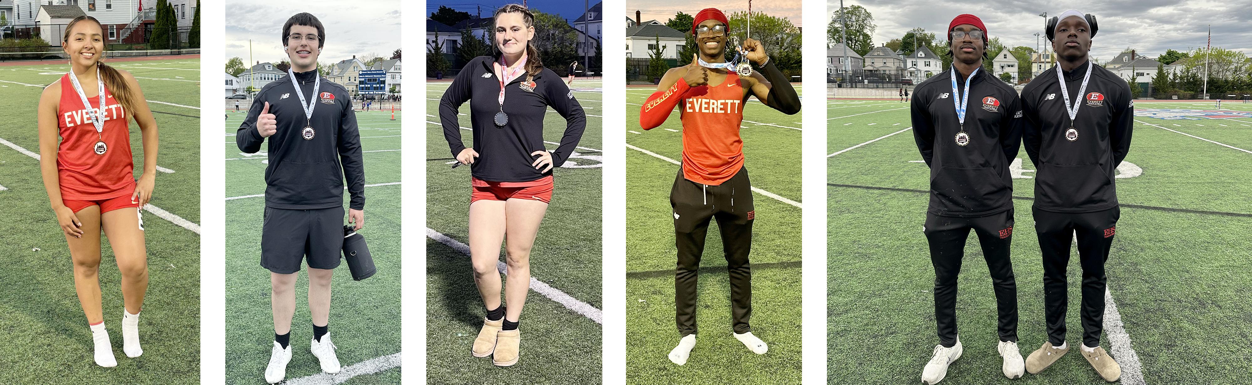 Five athletes wearing Everett sports uniforms and medals on a field.