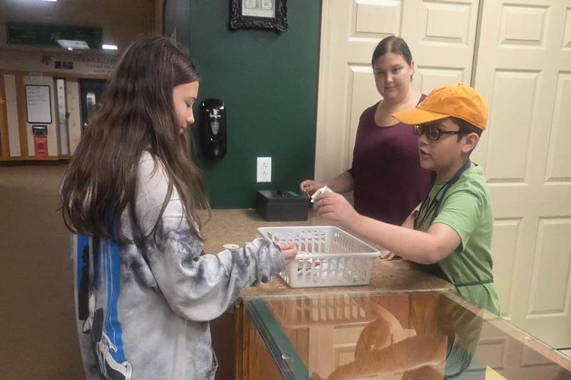 A student pays another student at the snack counter