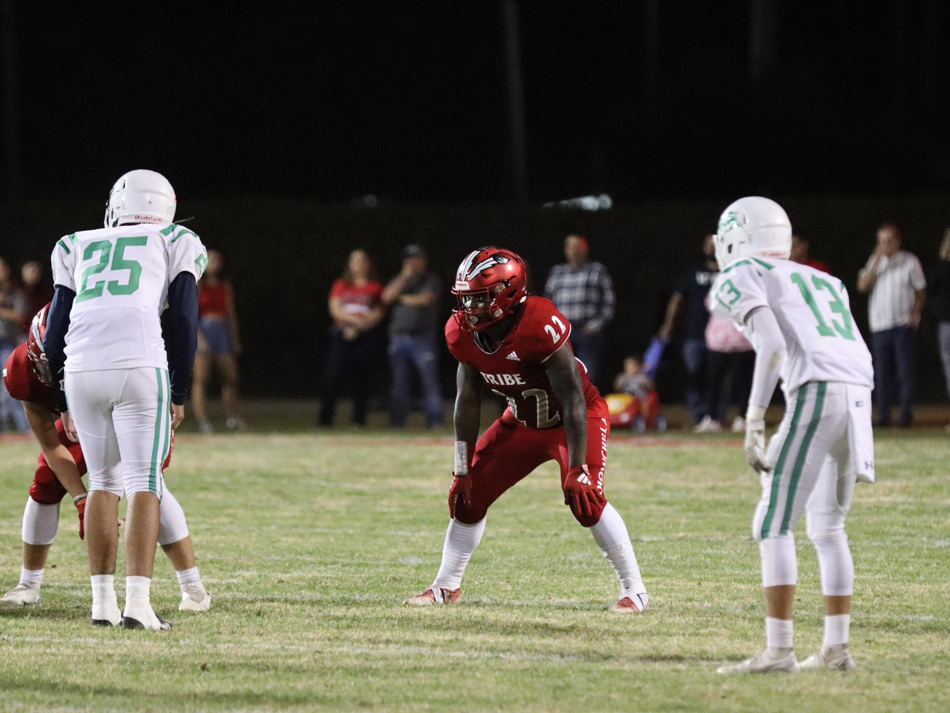 varsity football players in action against Riverdale