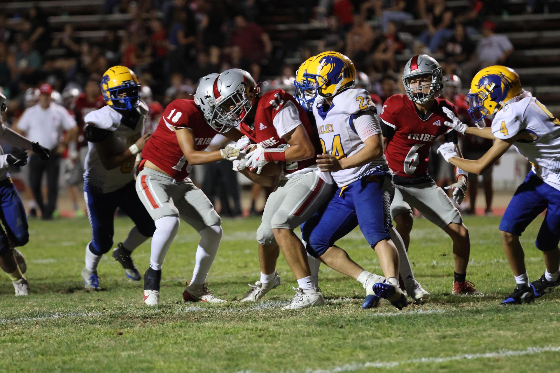 Varsity football players in action against Parlier 112