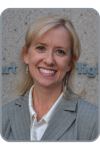 Jan Daisher, a blond woman in a grey blazer smiling