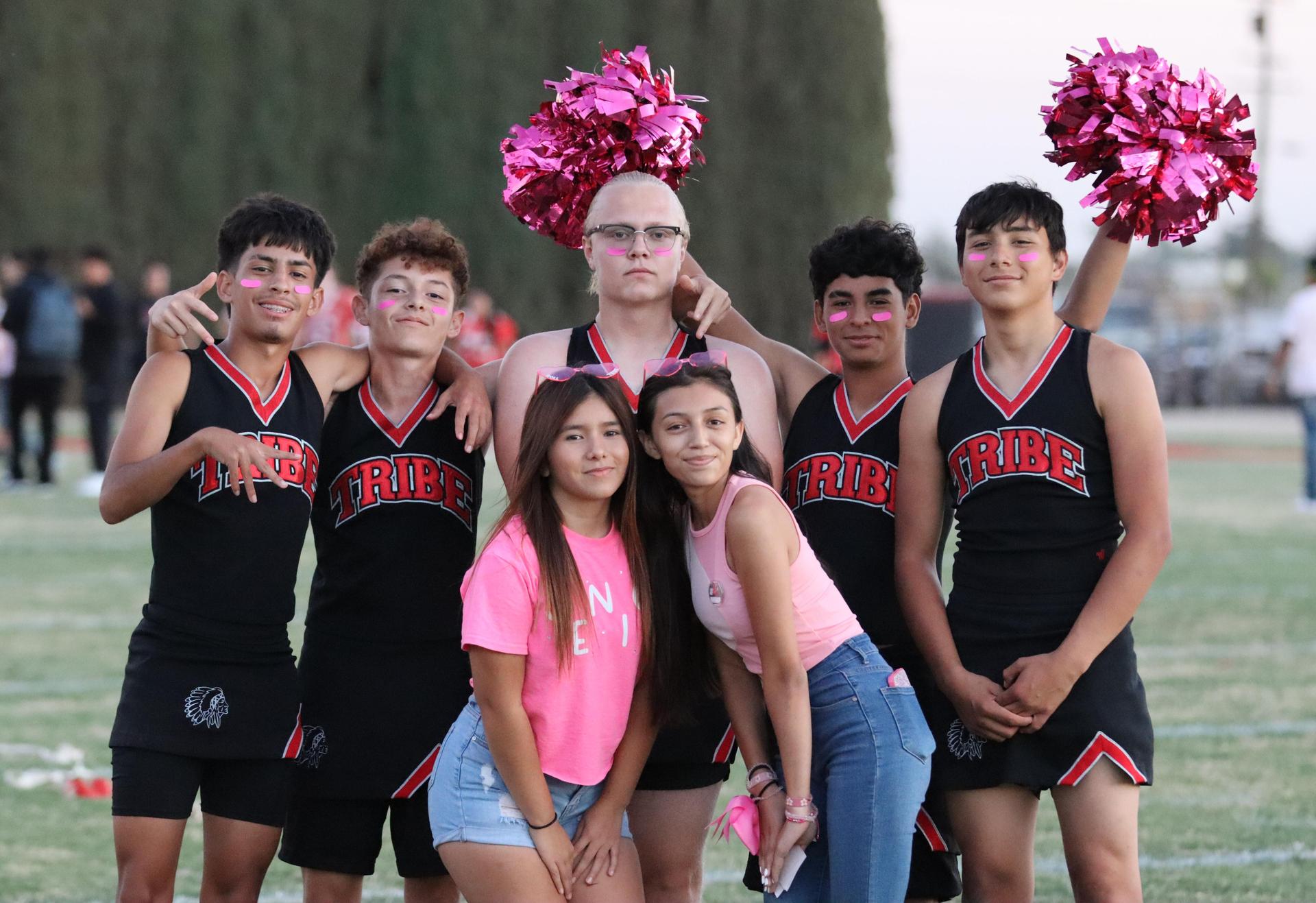 players, cheerleaders, and officials preparing for the powderpuff football game