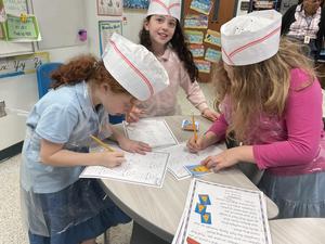Three girls working together at the math bakery.