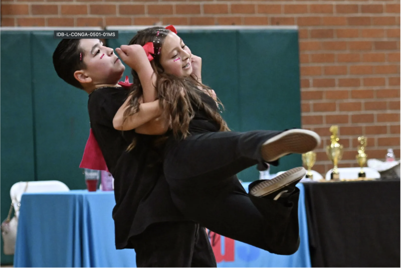 student lints another while dancing