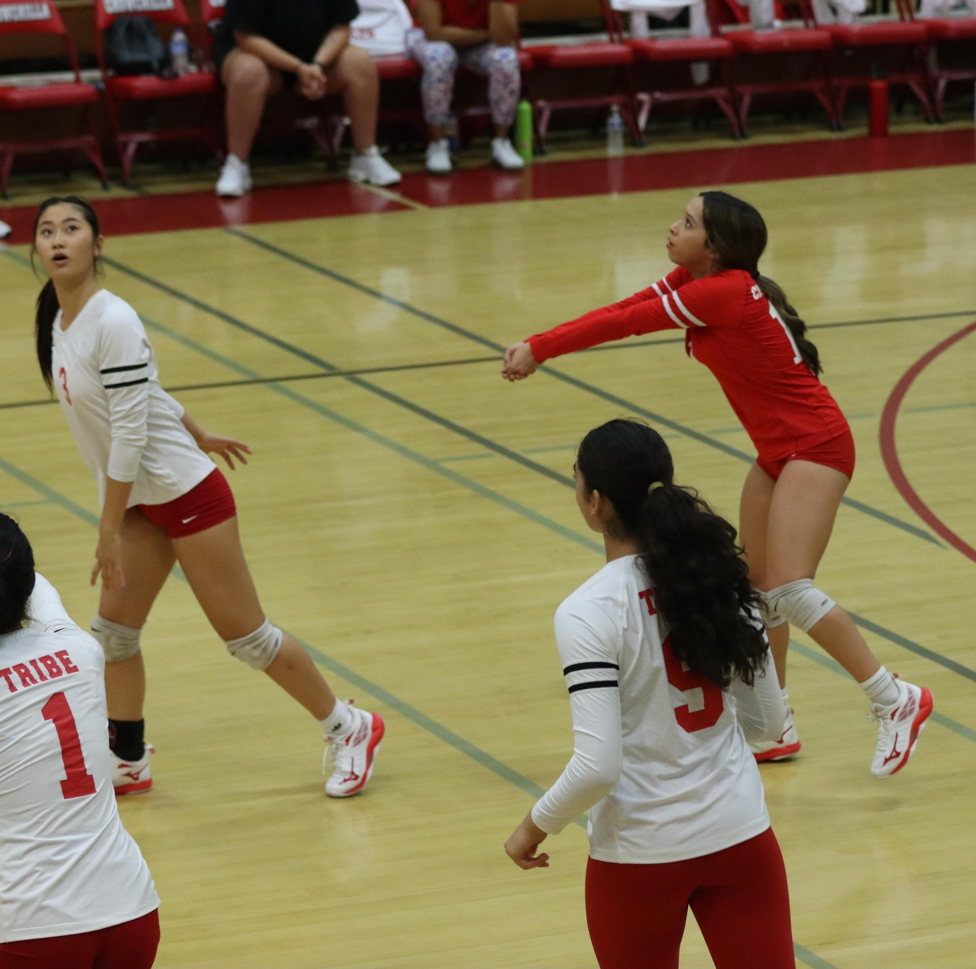 varsity volleyball players in action against golden valley
