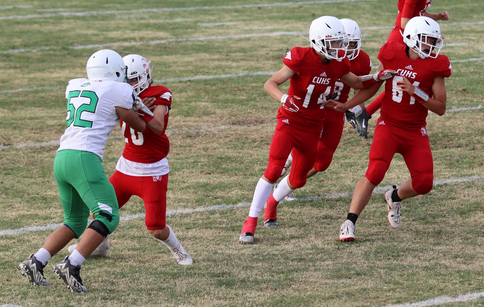  junior varsity football players in action against riverdale