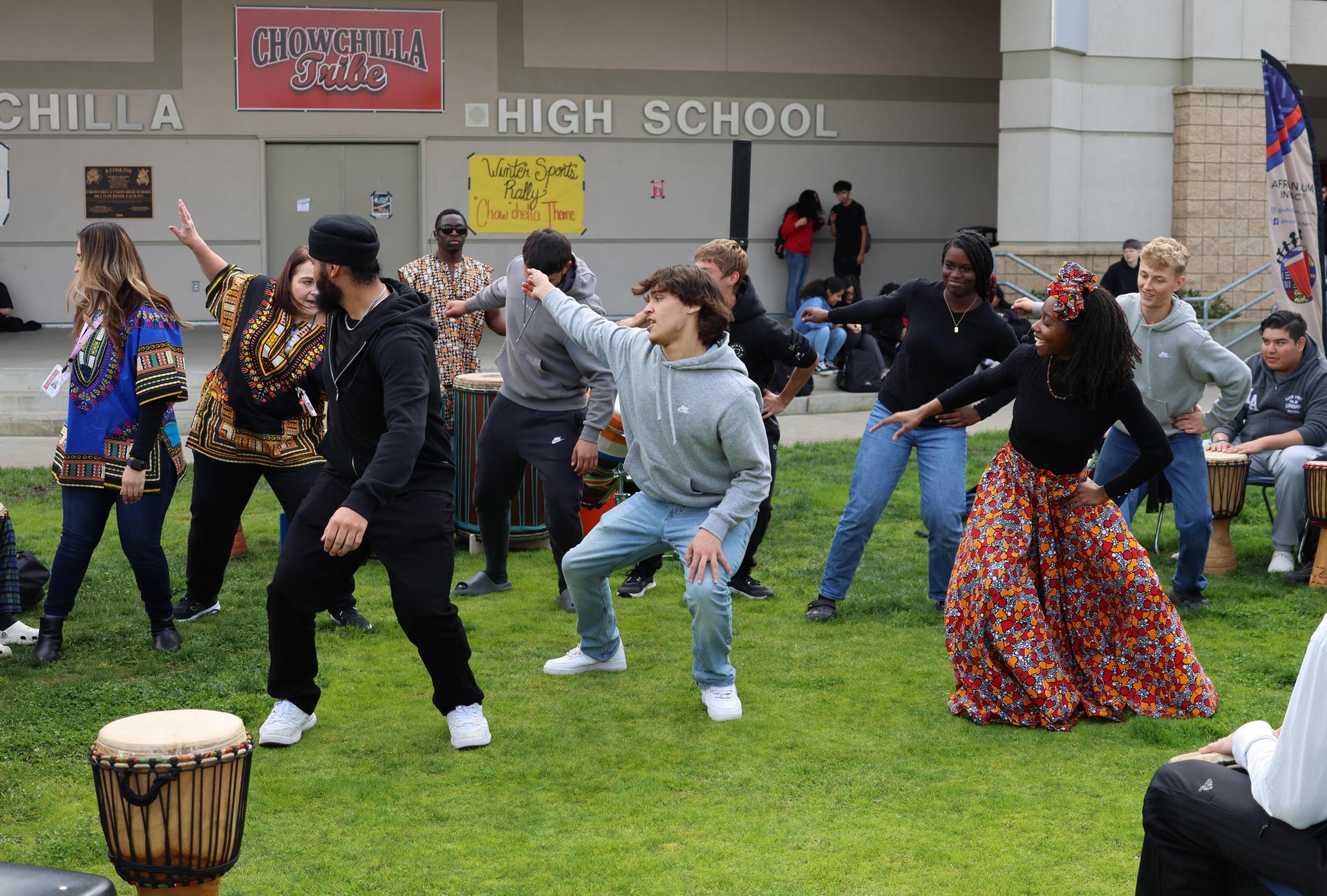 students and staff participating with the African Drum Interactive