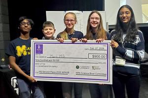 Five students holding an oversized check for $900