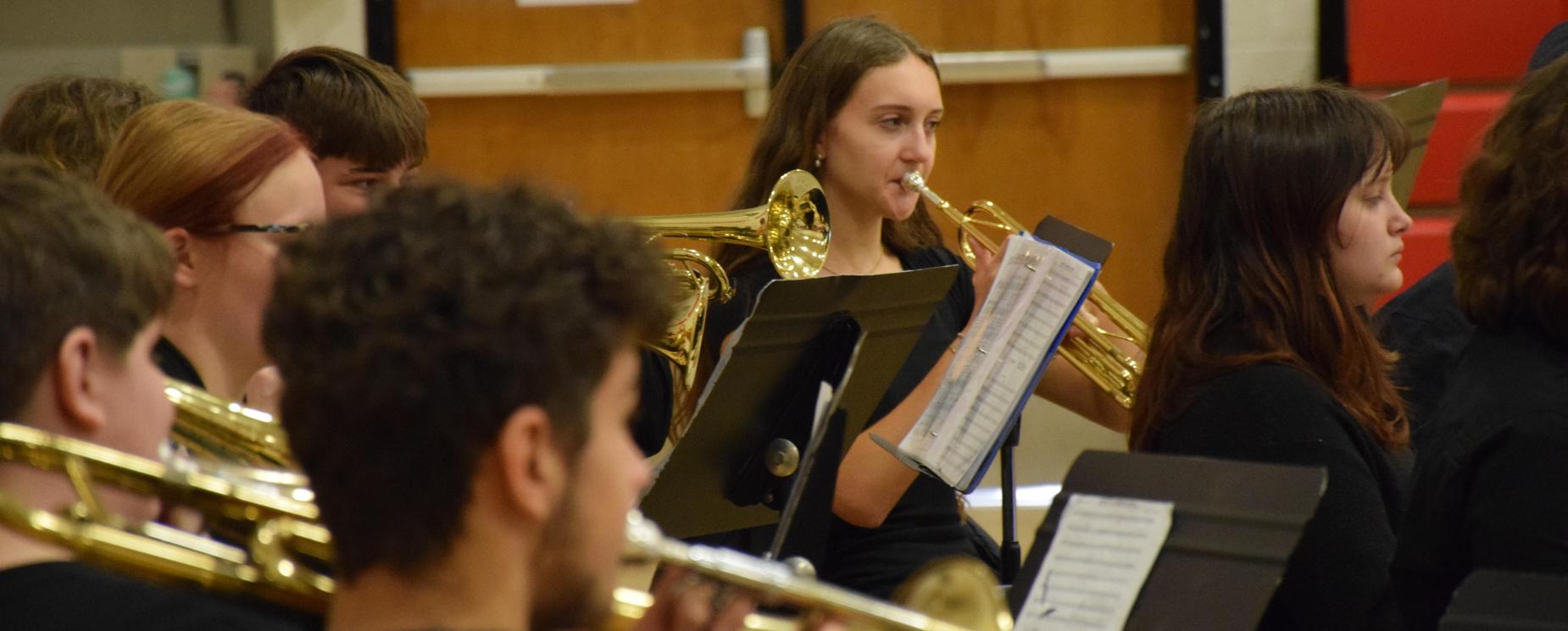 High school band performing with instruments