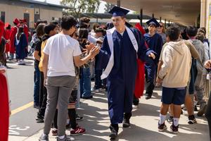 Former MSD Student giving a high five to Magnolia Students