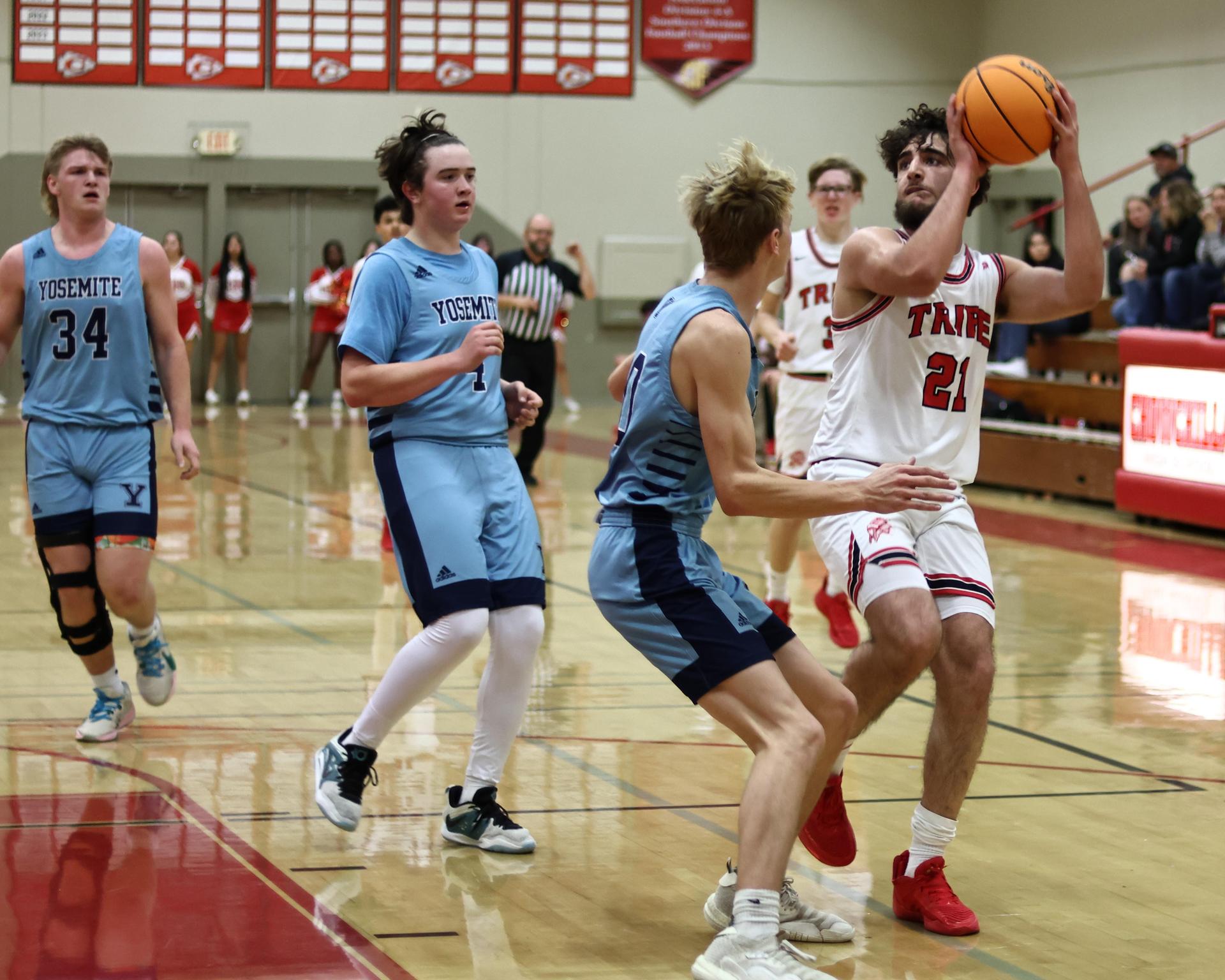 Varsity boys playing basketball against yosemite