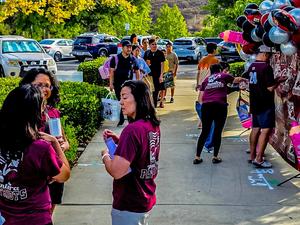 parents and families in front of school decorating