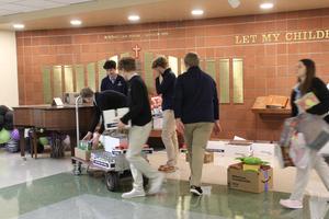 students packing boxes