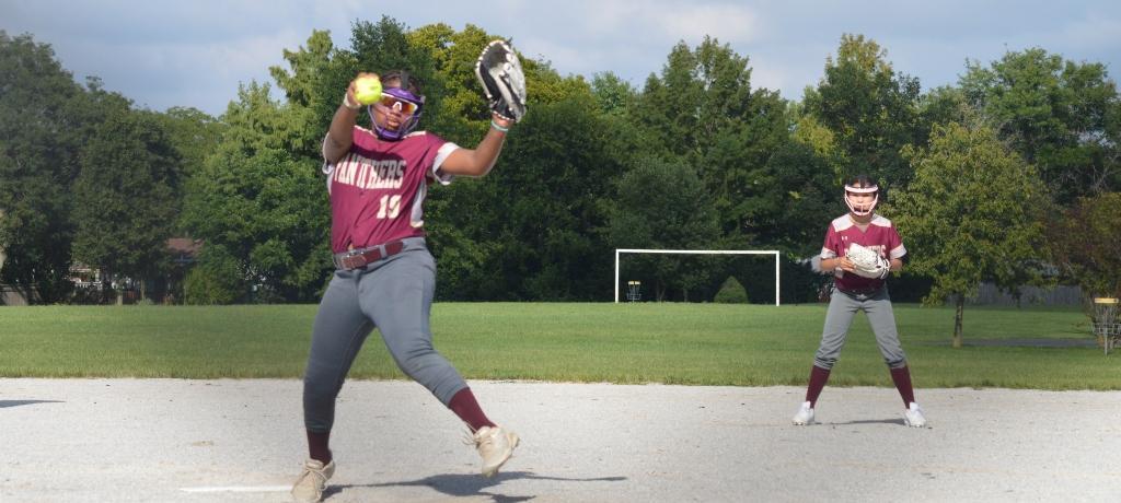 Softball pitcher winds up.