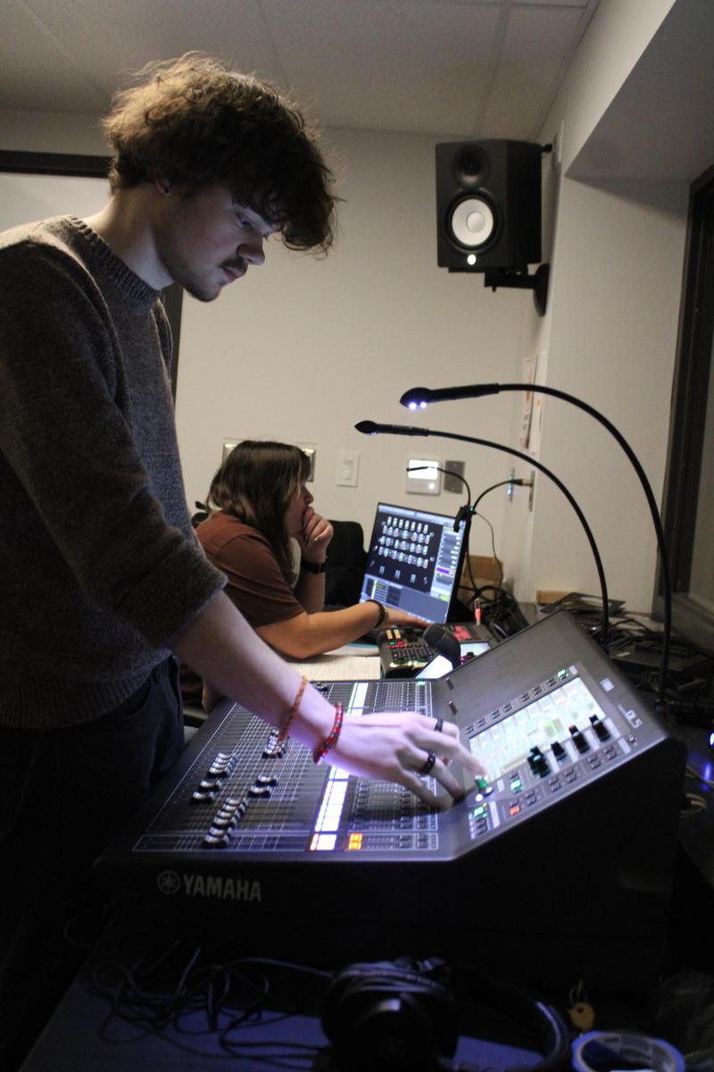 students working on lights and sounds in the booth