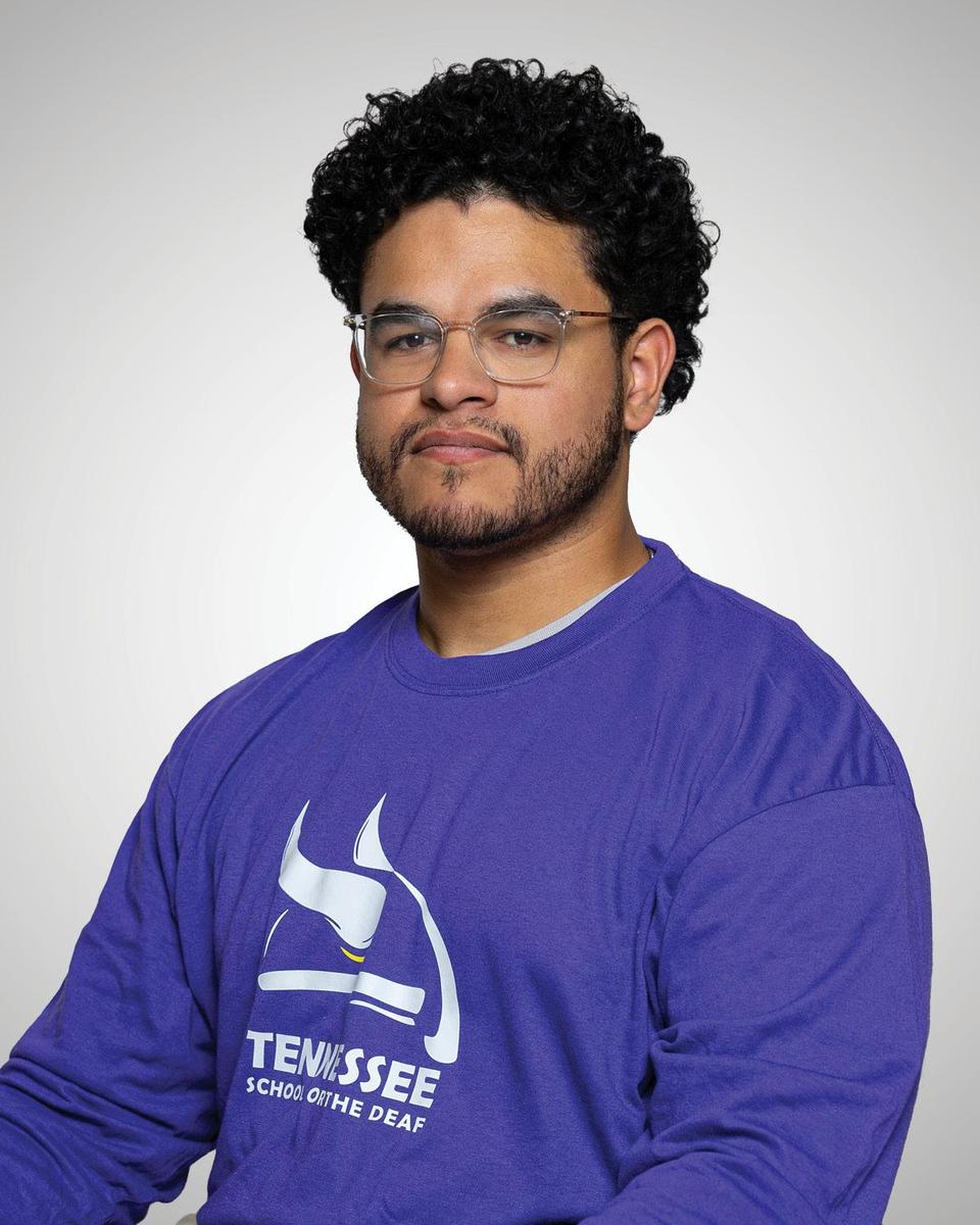 Male Head Coach posing with serious stature for a picture