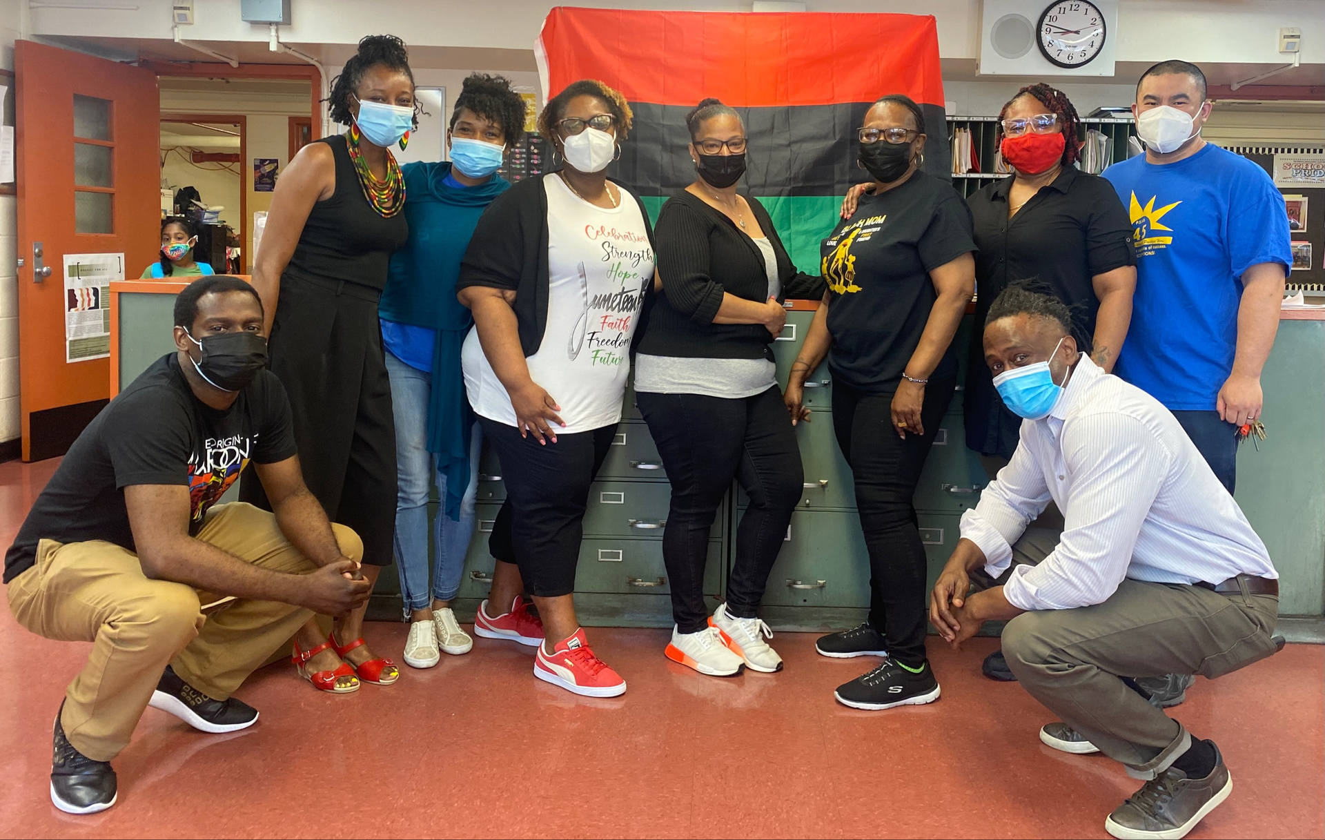 Staff picture in main office representing colors for Juneteenth.