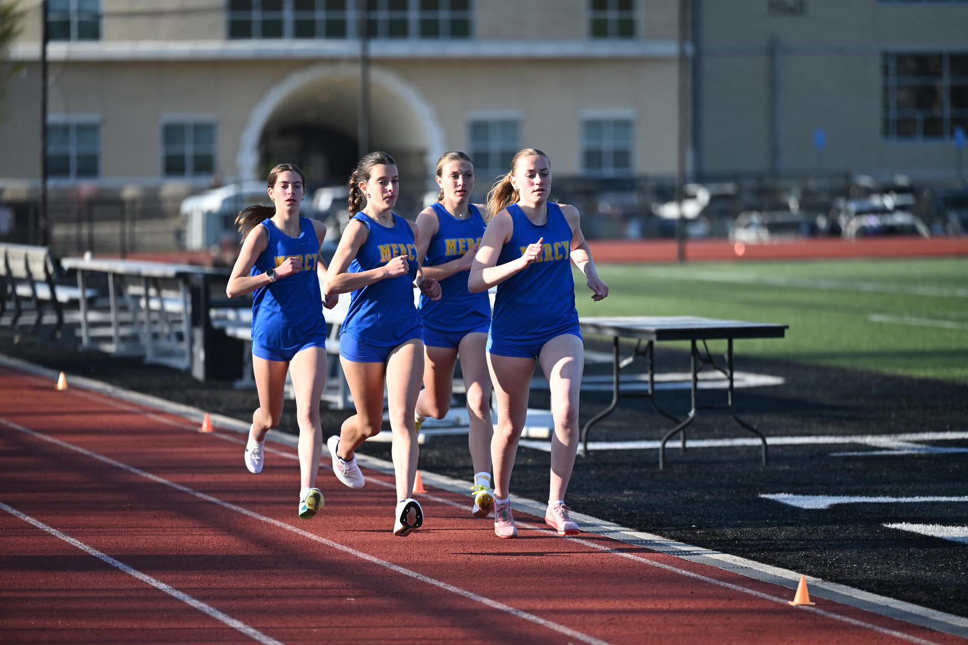 Track Athletes Running Together At A Meet