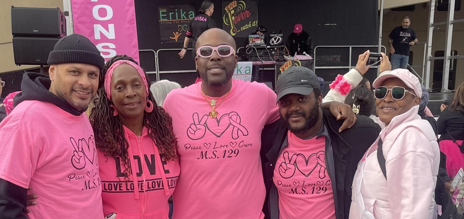 Five people wearing pink standing together at the Making Strides Breast Cancer Walk