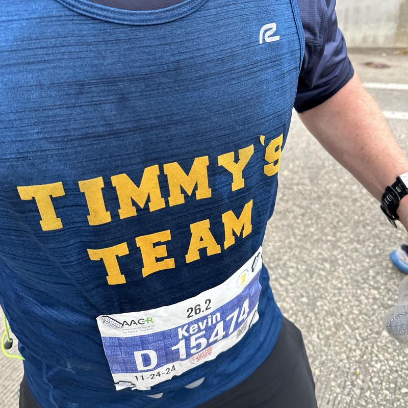 Man wearing Timmy's Team shirt with marathon sticker