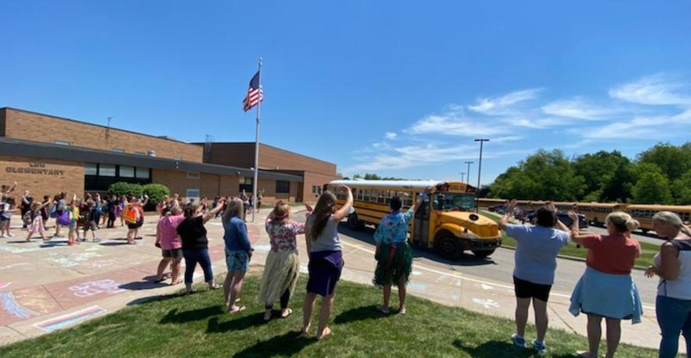 Lee staff wave goodbye on the last day of school.