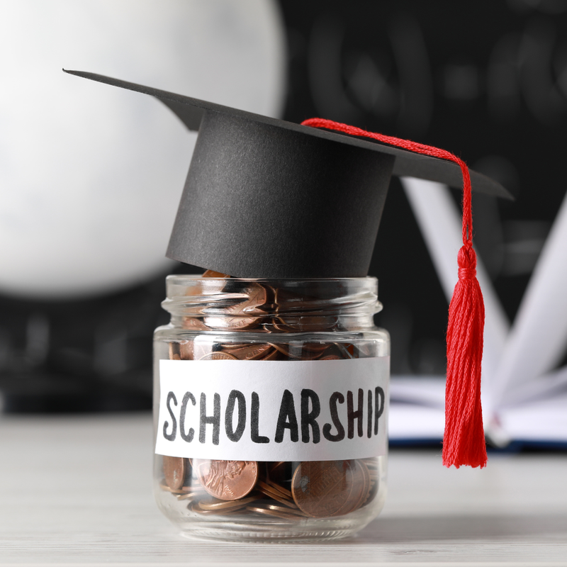 scholarship hat on top of money jar