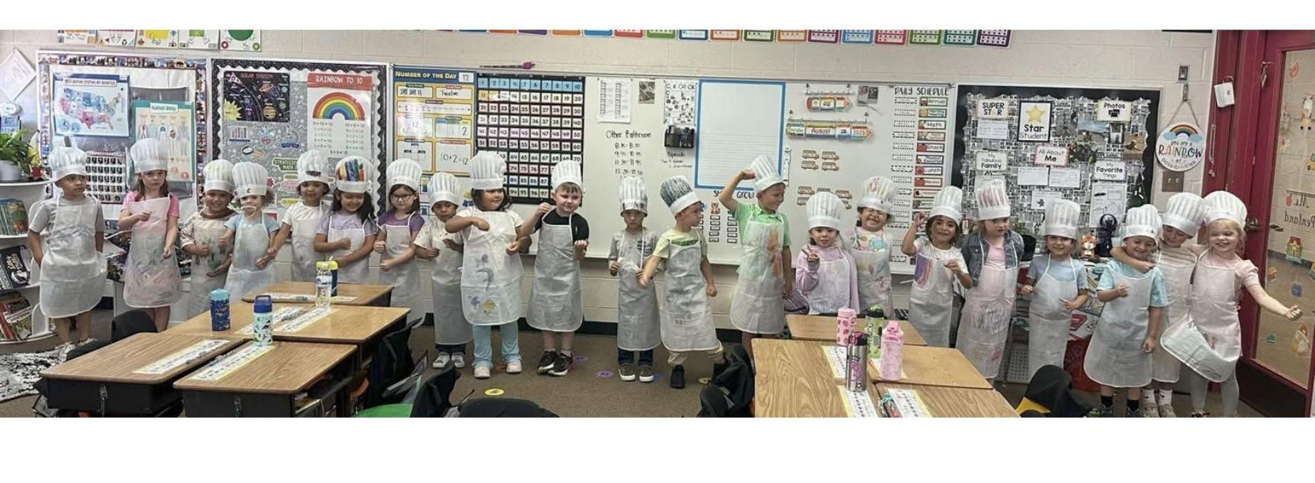 BES Kindergarten students in chef hats and aprons.