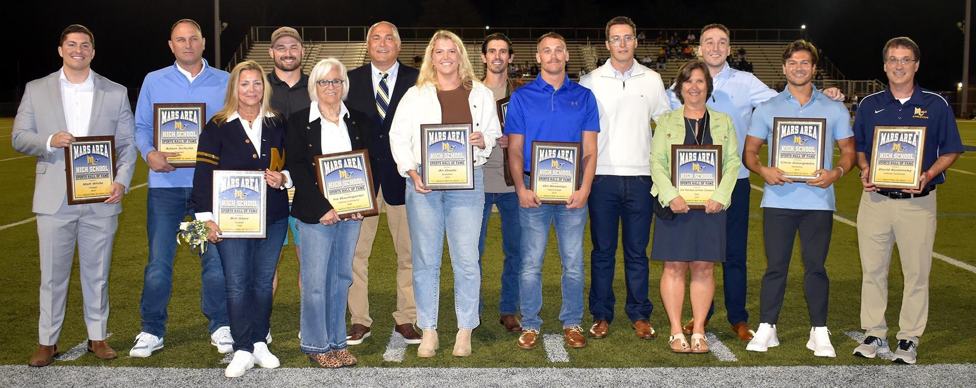 a group of people holding plaques