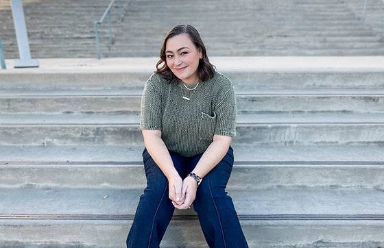 Assistant Principal Guthrie sits on steps.