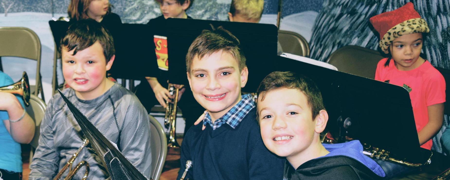 Four Cumberland Head students smile during their Band class