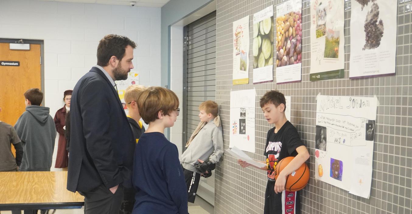 TK Superintendent is among the guests vising the Page Wax Museum and stops to listen to one student present information.