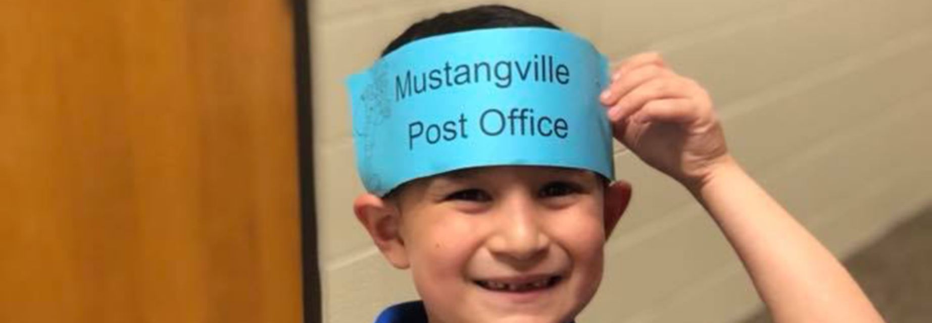 boy with Mustangville Post Office cap