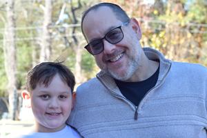 a father and son pose at the fall festival