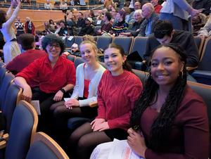 Performers seated in the audience
