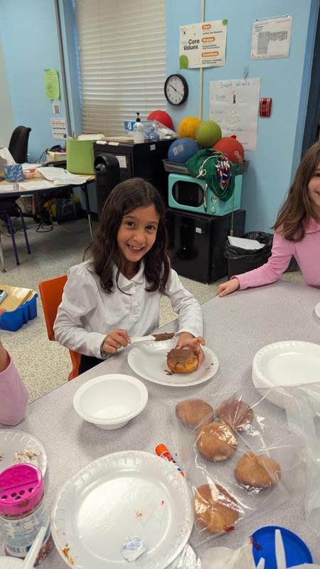 another second grader decorating a donut