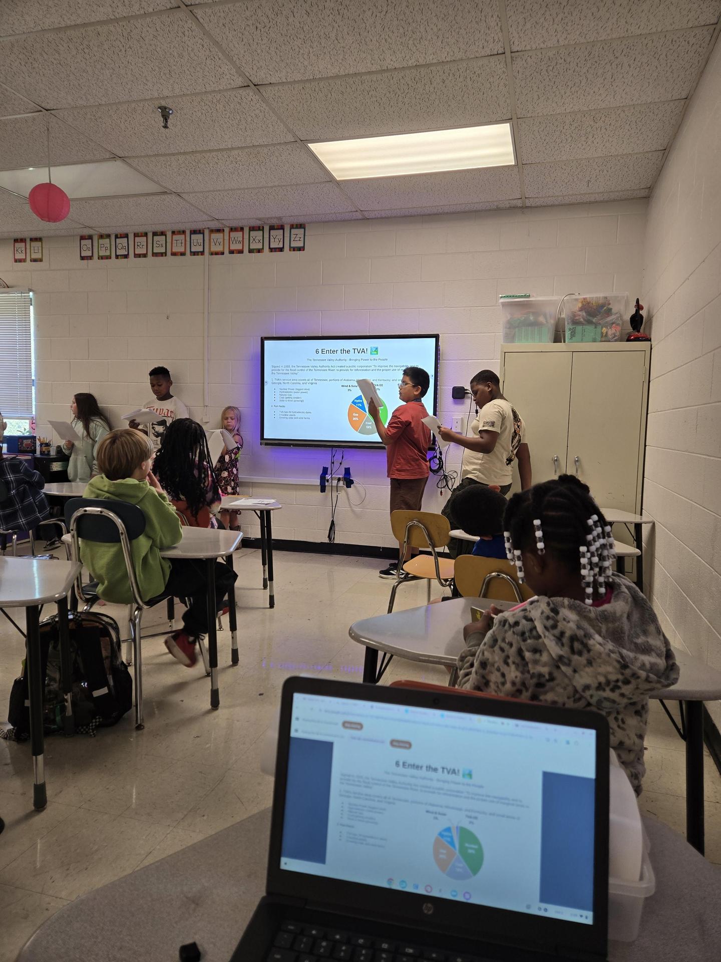 students reading presentations on electricity
