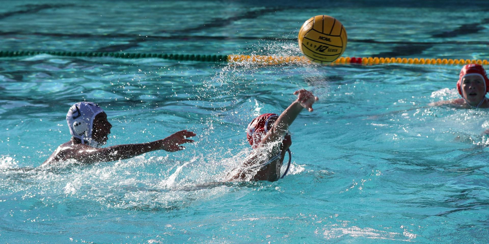 boys water polo players in action against hoover