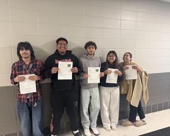 students holding certs