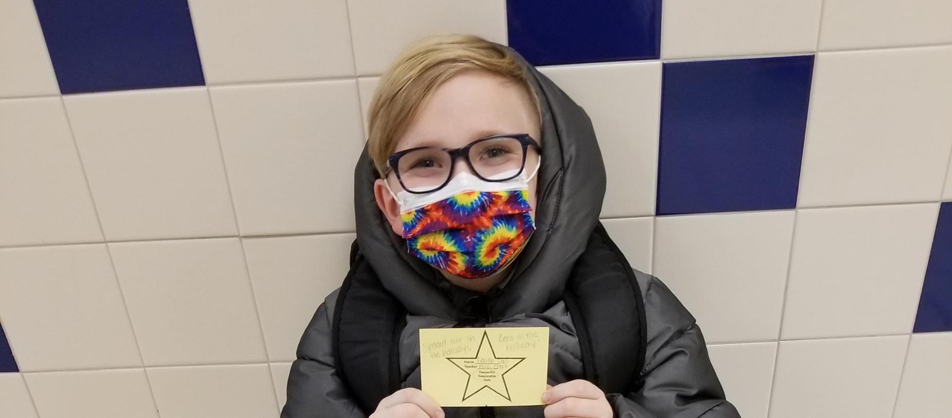 student wearing mask posing for the camera