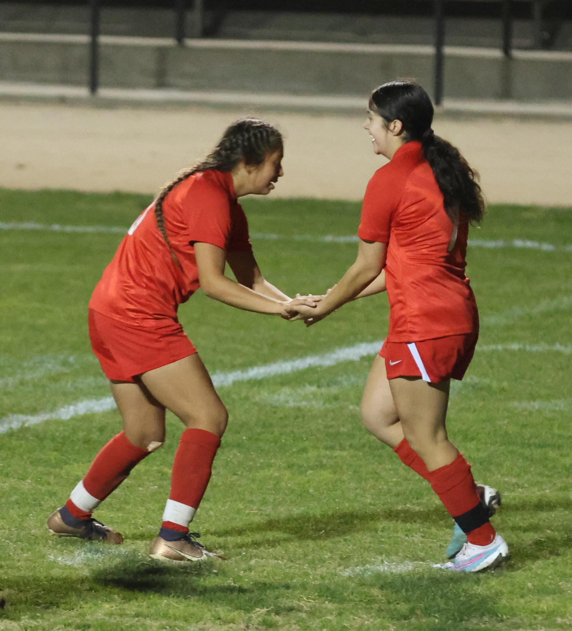 Varsity girls playing soccer against sunnyside