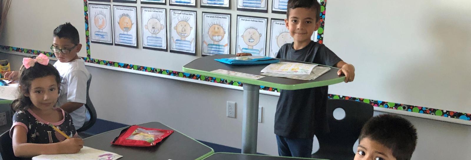 A Roosevelt student chooses to complete his classwork standing up. Adjustable student desks offer our scholars alternatives to traditional learning.