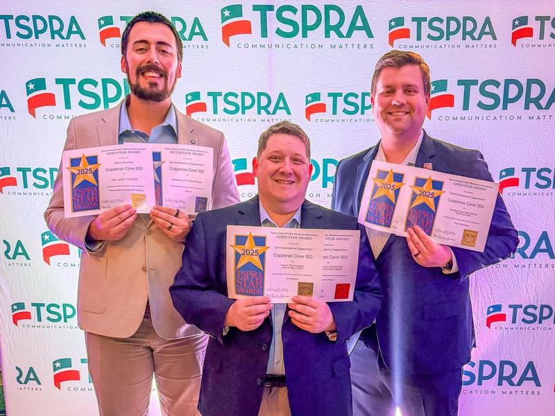 Three men smiling and holding awards