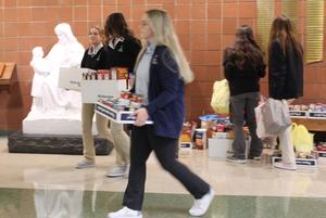 students carrying boxes