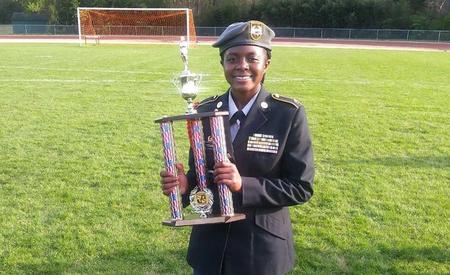 student holding trophy
