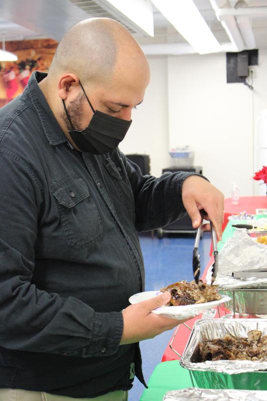 Bald teacher serving himself food